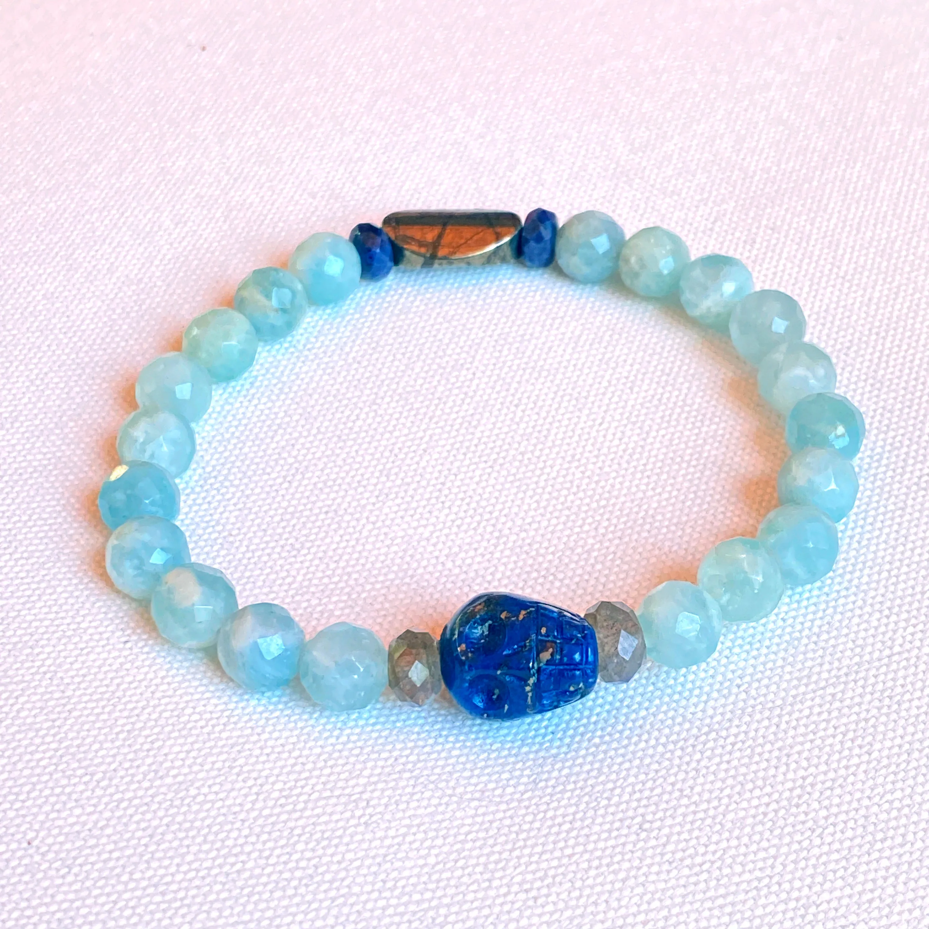 Lapis lazuli skull, pyrite, Labradorite, and blue sapphire stretch bracelet