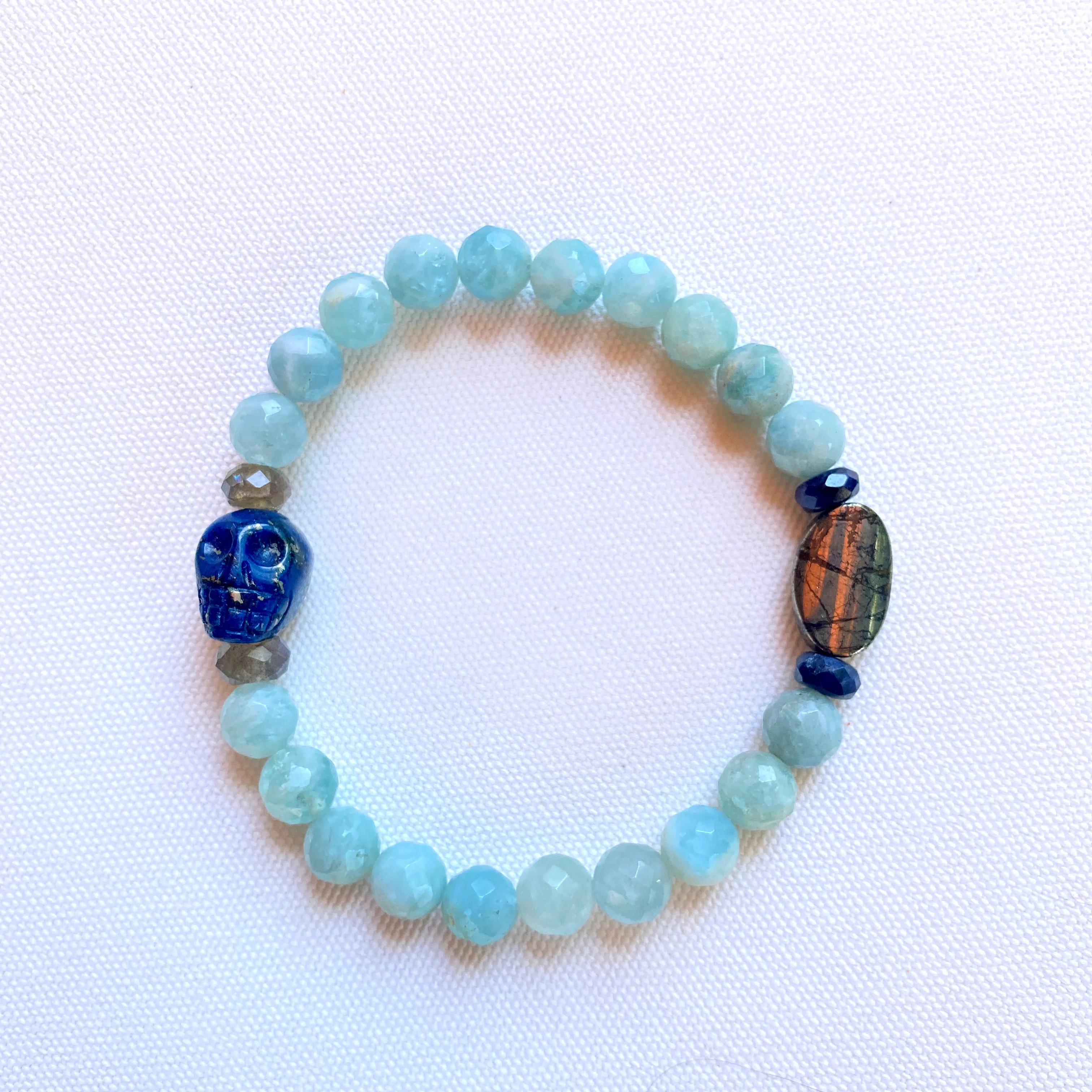 Lapis lazuli skull, pyrite, Labradorite, and blue sapphire stretch bracelet